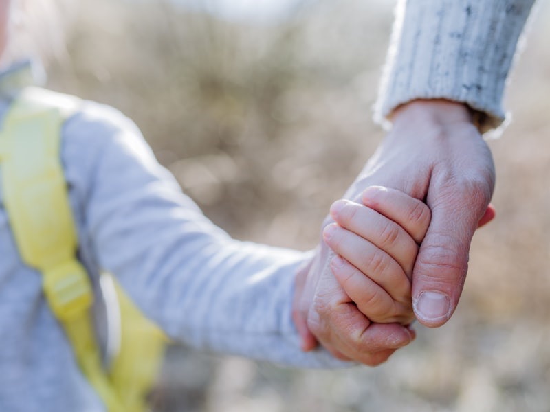 Hands resting gently together, conveying warmth and connection
